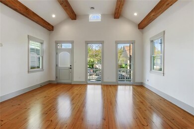 Living Room Features Tall Ceilings w/ Exposed Beam