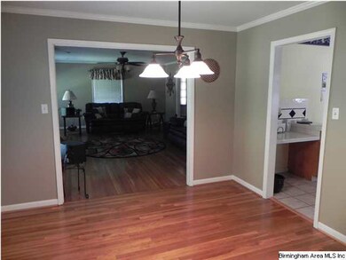 FORMAL DINING ROOM WITH HARDWOOD FLOORS.