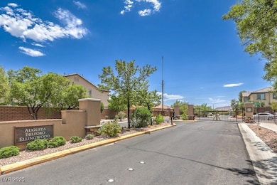 View of asphalt street featuring a gate, a gated e