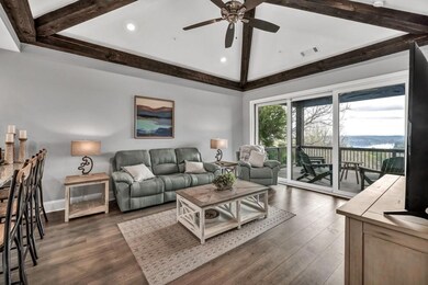 Living area with a ceiling fan, dark wood finished