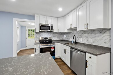 Kitchen with stainless steel appliances, white cab