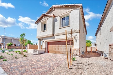 View of front of property featuring stucco siding, a garage, and decorative driveway