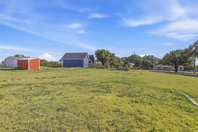 View of grassy yard with an outdoor structure