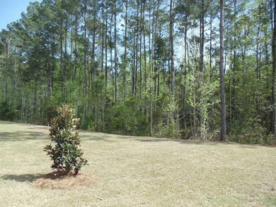 View of green lawn with a view of trees