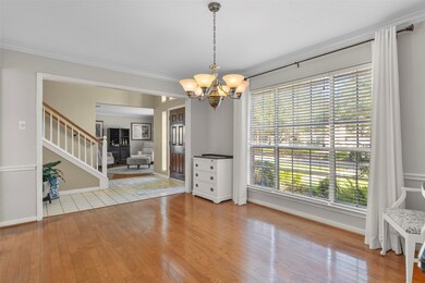 To the left side of the foyer, a wide entrance ope