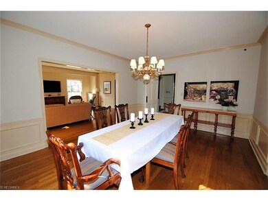 Dining room with crown molding, hardwood floors an