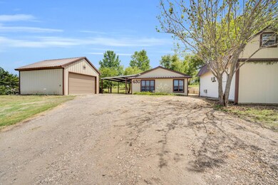 Ranch-style home with a garage, a carport, and an 
