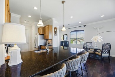 Kitchen with crown molding, a sink, a breakfast b