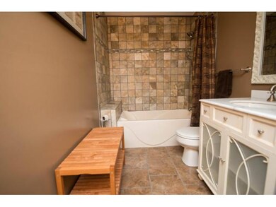 This luxurious bath features stone tile and feels 