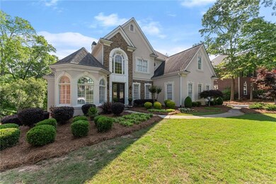 View of front of home with a shingled roof, stucco