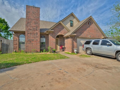 View of front of property featuring roof with shingles, brick siding, driveway, a front lawn, and an attached garage