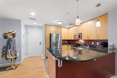 View of front door and kitchen.