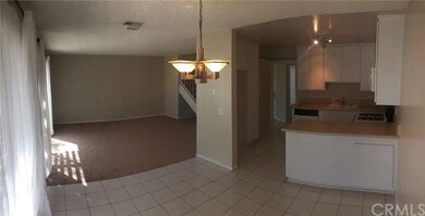 View from corner of dining area into kitchen and l