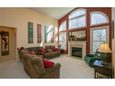 Great Room w/ vaulted ceilings and large windows o