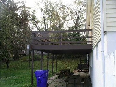 Exterior Back. Large deck with covered patio.