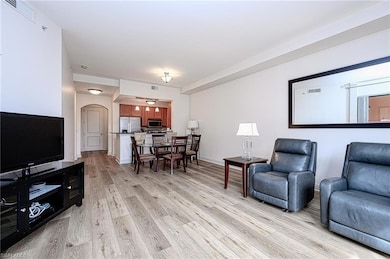 Living room with light hardwood / wood-style floor