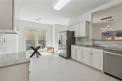 Kitchen with stainless steel appliances, a sink, b