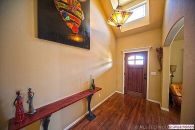 Dramatic foyer features high ceilings and skylight
