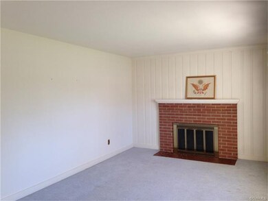 wood burning fireplace in this large living room w