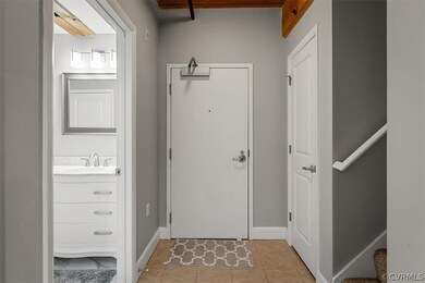 Entrance foyer with sink and light tile patterned