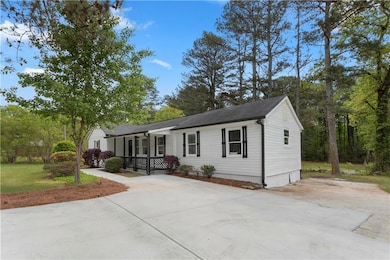 Home featuring a porch and concrete driveway