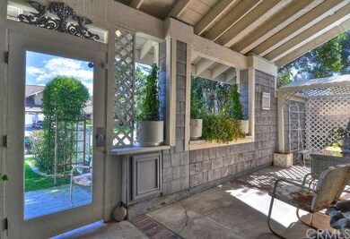 Covered front patio with glass door entrance and s