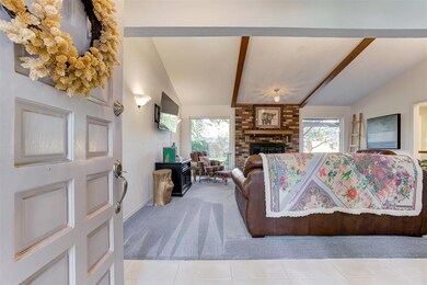 Living room with a fireplace, light tile patterned