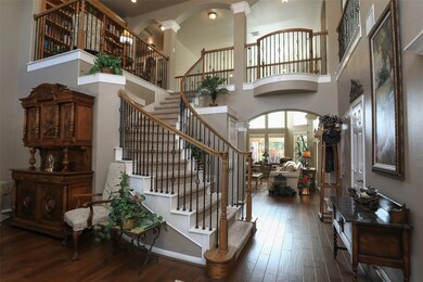 Step inside the front door and take in the soaring 2-story entryway with sweeping staircase with wrought-iron banister!