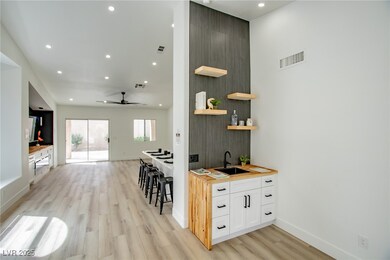 Wet Bar featuring visible vents, light wood-style