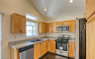 Kitchen featuring stainless steel appliances, a si