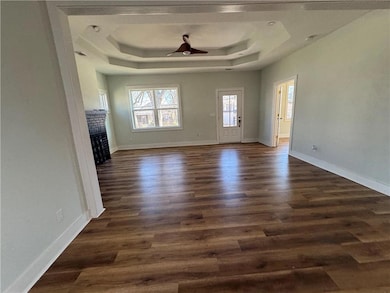 Unfurnished living room featuring dark wood finish