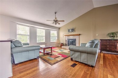 The open floor plan features a newer bamboo floor 