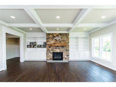 Comfortable family room with wood floors, coffered
