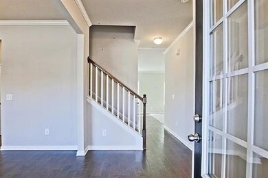 Foyer entrance with crown molding, wood finished f