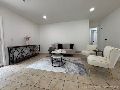 Tiled living room with recessed lighting