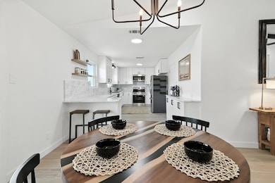 Dining space with a chandelier and light wood fin