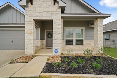 View of front of home with covered porch, stone si