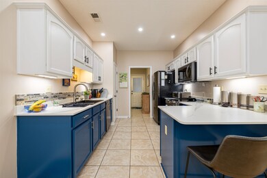 Kitchen with a breakfast bar, blue cabinets, sink,