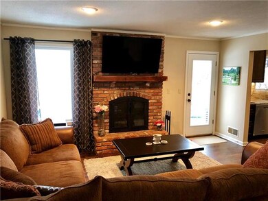 Living Room with entrance to backyard! Cozy firepl