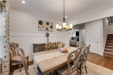 Dining room featuring a decorative wall, a chandel