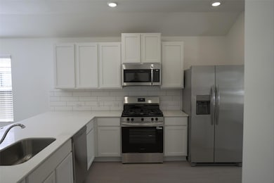 Kitchen featuring appliances with stainless steel