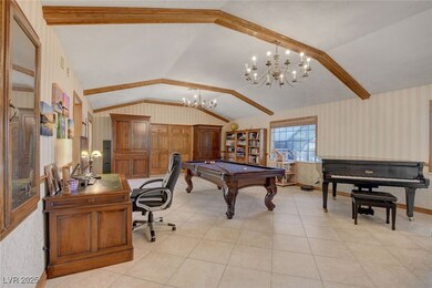 Great room with vaulted ceiling, wallpapered walls