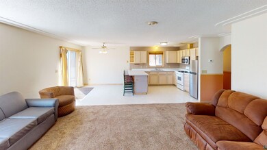 Living room featuring sink, a textured ceiling, ce