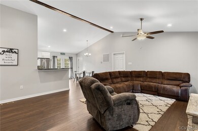 Living room with vaulted ceiling, dark hardwood /