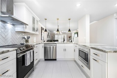 Kitchen with wall chimney exhaust hood, appliances
