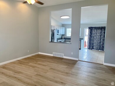 Unfurnished living room with light wood-style floors and ceiling fan