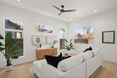 Living room featuring baseboards, light wood fini