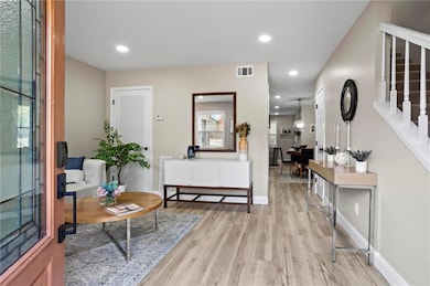 Entrance foyer with light hardwood / wood-style floors