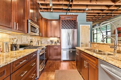 Kitchen featuring a sink, backsplash, appliances 