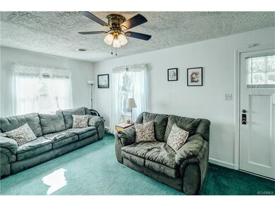 Spacious Family Room with lots of light!  Hardwood floors under carpet, New Ceiling Fan and Fresh Paint all over!